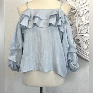 Women’s blue ruffled top with open shoulders